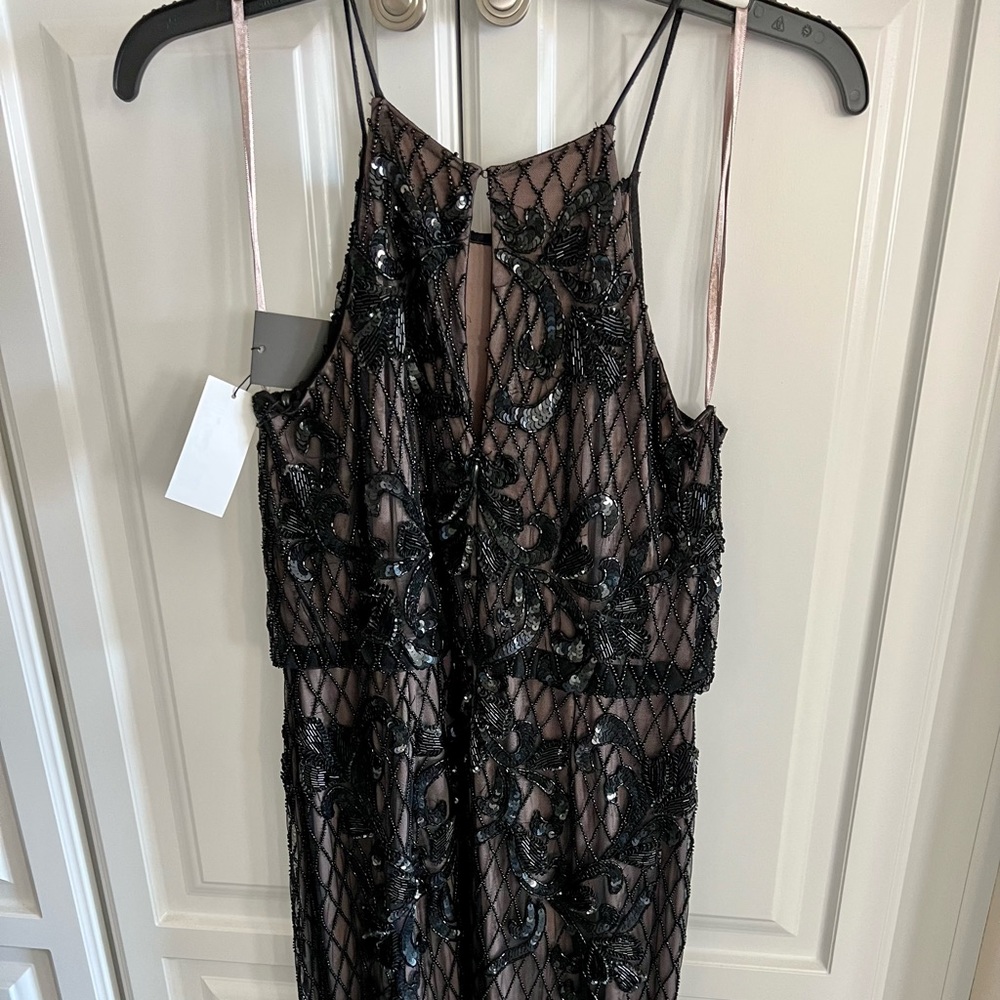 New. Stunning beaded mesh lined halter gown.